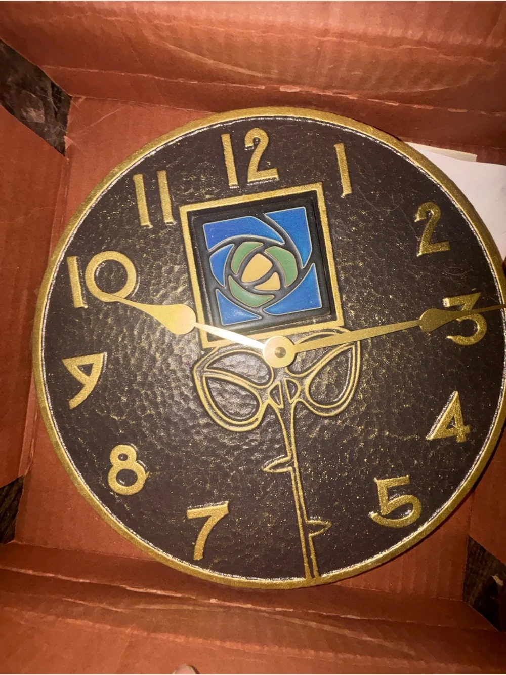 Textured Black Wall Clock with Gold Numerals and Blue-Green Accent